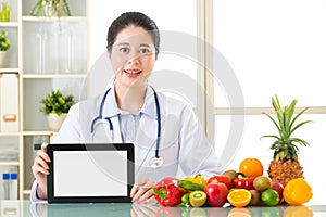 Doctor nutritionist with vegetable and fruit holding blank digit