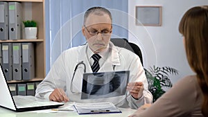 Doctor observing lungs x-ray, patient waiting for diagnosis, tuberculosis risk