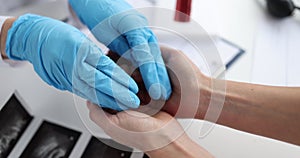 Doctor obstetrician gynecologist in gloves putting artificial model of fetus in palm of woman closeup 4k movie