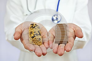 Doctor Offering Granola Bar and Chocolate