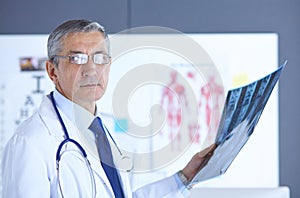 Doctor in the office examines the patient`s x-ray