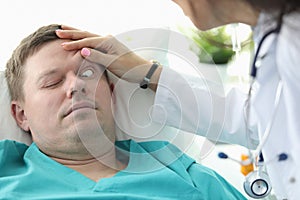 Doctor opens his eyes to patient unconscious clinic