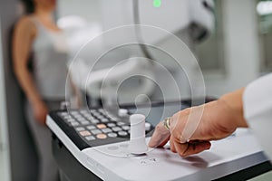 Doctor operating dynamic X-ray scan using tilting fluoroscopy unit