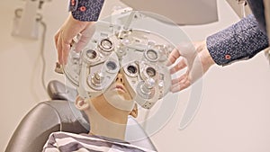 Doctor optometrist checks little boy's eyesight. Child in ophthalmologist room.