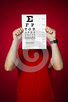 Doctor optometrist keeping an eye chart