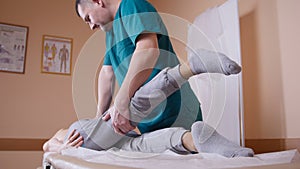 Doctor osteopath have manual therapy for woman`s leg