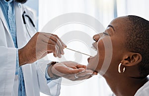 Doctor, otolaryngologist or dentist with a medical instrument checking the throat for tonsils or oral cancer. Health