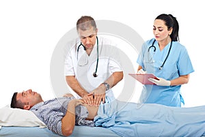 Doctor palpating patient abdomen photo