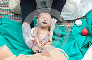 Doctor, paramedic, refresher training to assist childbirth newborn with medical dummy