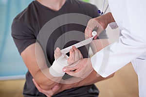 Doctor parceling patient's wrist photo