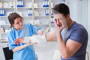 The doctor and patient during check-up for injury in hospital