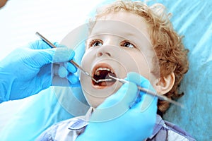 Doctor and patient child. Boy having his teeth examined with dentist. Medicine, health care and stomatology concept