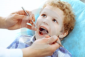 Doctor and patient child. Boy having his teeth examined with dentist. Medicine, health care and stomatology concept