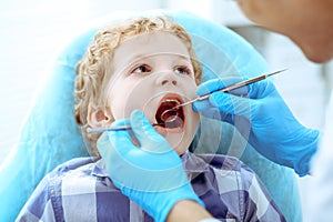 Doctor and patient child. Boy having his teeth examined with dentist. Medicine, health care and stomatology concept