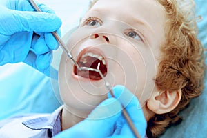 Doctor and patient child. Boy having his teeth examined with dentist. Medicine, health care and stomatology concept