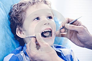 Doctor and patient child. Boy having his teeth examined with dentist. Medicine, health care and stomatology concept