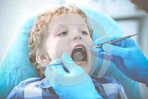 Doctor and patient child. Boy having his teeth examined with dentist. Medicine, health care and stomatology concept