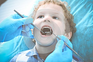 Doctor and patient child. Boy having his teeth examined with dentist. Medicine, health care and stomatology concept