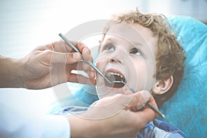 Doctor and patient child. Boy having his teeth examined with dentist. Medicine, health care and stomatology concept