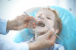 Doctor and patient child. Boy having his teeth examined with dentist. Medicine, health care and stomatology concept