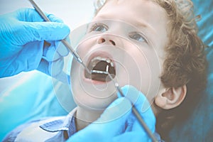 Doctor and patient child. Boy having his teeth examined with dentist. Medicine, health care and stomatology concept