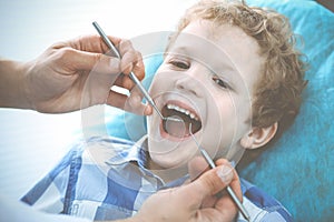 Doctor and patient child. Boy having his teeth examined with dentist. Medicine, health care and stomatology concept