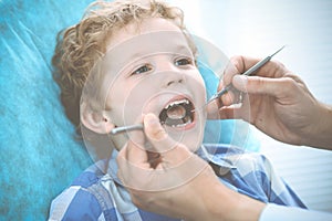 Doctor and patient child. Boy having his teeth examined with dentist. Medicine, health care and stomatology concept