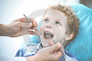 Doctor and patient child. Boy having his teeth examined with dentist. Medicine, health care and stomatology concept