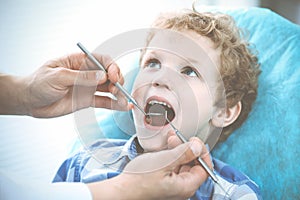 Doctor and patient child. Boy having his teeth examined with dentist. Medicine, health care and stomatology concept