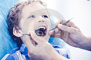 Doctor and patient child. Boy having his teeth examined with dentist. Medicine, health care and stomatology concept