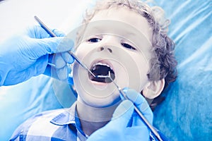 Doctor and patient child. Boy having his teeth examined with dentist. Medicine, health care and stomatology concept