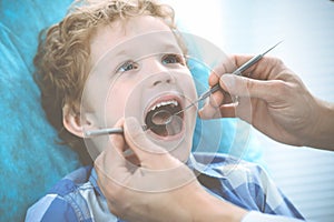 Doctor and patient child. Boy having his teeth examined with dentist. Medicine, health care and stomatology concept