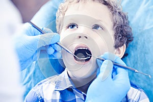 Doctor and patient child. Boy having his teeth examined with dentist. Medicine, health care and stomatology concept