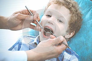 Doctor and patient child. Boy having his teeth examined with dentist. Medicine, health care and stomatology concept