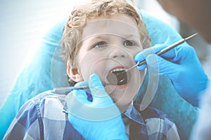 Doctor and patient child. Boy having his teeth examined with dentist. Medicine, health care and stomatology concept