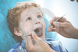 Doctor and patient child. Boy having his teeth examined with dentist. Medicine, health care and stomatology concept