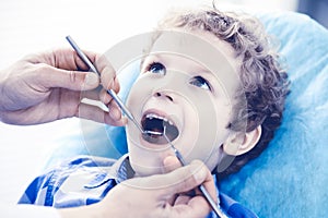 Doctor and patient child. Boy having his teeth examined with dentist. Medicine, health care and stomatology concept