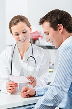 Doctor with patient in clinic consulting