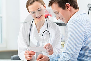 Doctor with patient in clinic consulting