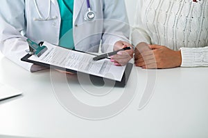 Doctor and patient, close-up of hands. Physician talking about medical examination results. Medicine, healthcare an