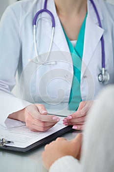 Doctor and patient, close-up of hands. Physician talking about medical examination results. Medicine, healthcare an