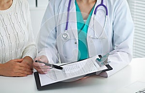 Doctor and patient, close-up of hands. Physician talking about medical examination results. Medicine, healthcare an