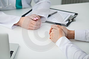 Doctor and patient, close-up of hands. Physician talking about medical examination results. Medicine, healthcare an