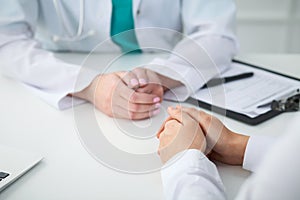 Doctor and patient, close-up of hands. Physician talking about medical examination results. Medicine, healthcare an