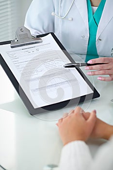 Doctor and patient, close-up of hands. Physician talking about medical examination results. Medicine, healthcare an