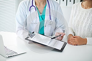 Doctor and patient, close-up of hands. Physician talking about medical examination results. Medicine, healthcare an