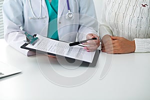 Doctor and patient, close-up of hands. Physician talking about medical examination results. Medicine, healthcare an