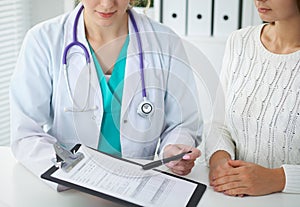 Doctor and patient, close-up of hands. Physician talking about medical examination results. Medicine, healthcare an