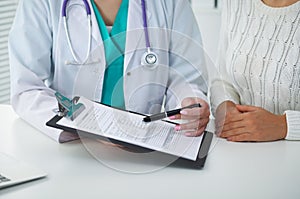 Doctor and patient, close-up of hands. Physician talking about medical examination results. Medicine, healthcare an