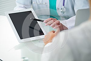 Doctor and patient, close-up of hands. Physician talking about medical examination results. Medicine, healthcare an